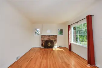 Freshly painted, golden hardwood floors and a wood burning fireplace makes this living room so very inviting!Chimney has been inspected and new damper installed in 2018.
