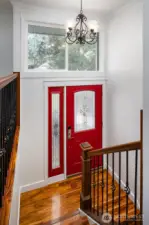 Light-filled entryway featuring engineered hardwood stairs.