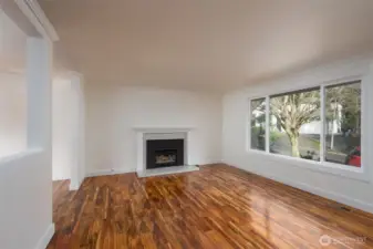 Spacious living room featuring a gas fireplace and large windows that flood the space with natural light.