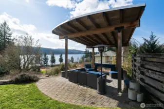 This beautiful covered pergola expands your outdoor living with gas fireplace and pull down screen for evening movie screenings.