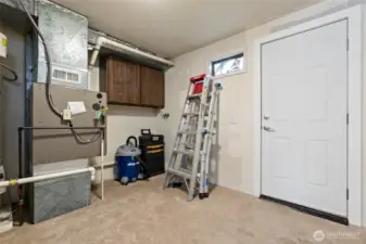 1013- Storage room on the back of garage. Furnace and water heater. Exterior door to fully fenced back yard.