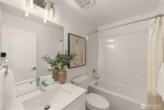 Step into a sleek and stylish bathroom featuring a modern vanity, timeless subway tiles, and a well-lit mirror that makes getting ready a breeze.
