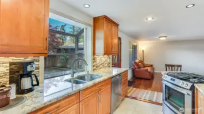Enjoy ample counter space, generous cabinet storage, and a charming pop-out window above the sink.