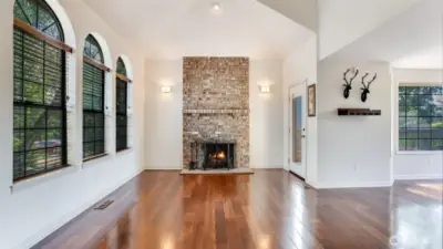 Cozy up by the rustic brick fireplace, side door leads to your backyard oasis!
