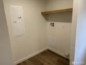 Laundry Room with electrical panel.