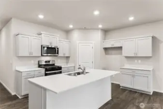 Lots of cabinets and eating space on island.