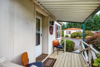 Welcoming front porch entry provides a cozy spot to greet friends and neighbors.
