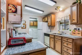 Warm cabinetry offers both charm and ample room for kitchen essentials.