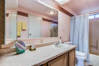 Large vanity with tons of counter & storage space plus an oversized mirror with bright lighting makes daily routines simple and comfortable.