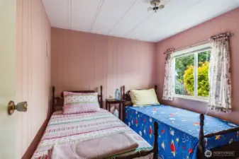 Cheerful guest room offers lots of natural light and space.