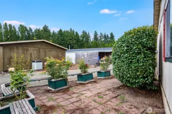 Brick-paved patio offers a charming spot for container gardening, fresh air, and relaxing afternoons.
