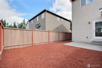 View of your backyard patio, back and side yards. Landscaping just refreshed, fully-fenced, talk about low maintenance!