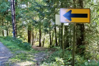 Driveway located next to yellow directional.