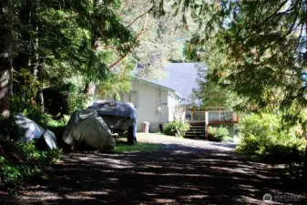 Long secluded driveway leads to the sunny waterfront lot.