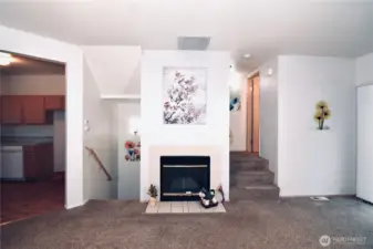 Living Area w/ Gas Fire Place - Main Level. Stairs Left to Garage - Lower Level, Stairs Right to Bedrooms Upper Level