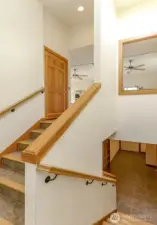 Tile Staircase with Fir trim to upstairs door for elevator. Solid core raised panel doors.