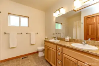 Master bathroom with double sinks and bathtub
