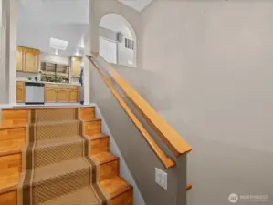 Wide stairs lead from the entry to the main living areas.
