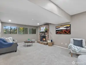 What a great family room! Loads of windows, new carpeting, brick faced wood burning fireplace.