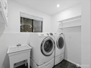 Great laundry room with utility sink. The washer and dryer stay with the home.