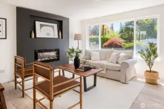 Light-filled living space with generous windows and flexible furniture placement options. Image from earlier listing in Sep 2025.