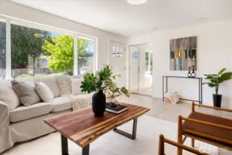 Light-filled living space with generous windows and flexible furniture placement options. Image from earlier listing in Sep 2025.