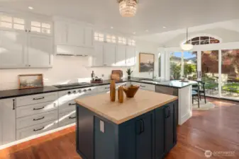 The gourmet kitchen is a chef’s dream, featuring custom cabinetry, rich soapstone countertops, and top-of-the-line appliances from Wolf, Sub-Zero, and Asko. Thoughtful details anticipate every need, with toe kick lighting, double sinks, and touch activated faucet