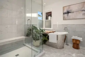 Primary Bedroom on this level is a spacious retreat with all the amenities needed for a relaxing and rejuvenating atmosphere.  Make life simple with lighted closet organizers. In-spa bath with glass enclosed steam shower, free standing bathtub, heated floors and towel rack, dual sinks and plenty of cabinet space. High quality Kohler fixtures, mosaic marble, pewter sconces, hand rubbed antique brass, dual Robern medicine cabinets.