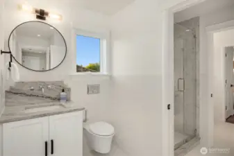 Jack and Jill bathroom maximizes space without compromising on style with built in vanity.