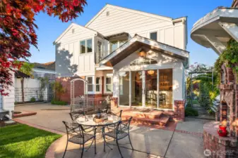 Step into the inviting backyard with old-world charm of a Tuscan villa, where dappled sunlight filters through mature maple trees. Ivy covered brick walls add privacy, making the patio with, BBQ grill,  the custom brick fireplace and pizza oven the perfect setting for sharing fine wine and memorable meals.