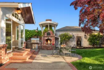 Step into the inviting backyard with old-world charm of a Tuscan villa, where dappled sunlight filters through mature maple trees. Ivy covered brick walls add privacy, making the patio with, BBQ grill,  the custom brick fireplace and pizza oven the perfect setting for sharing fine wine and memorable meals.