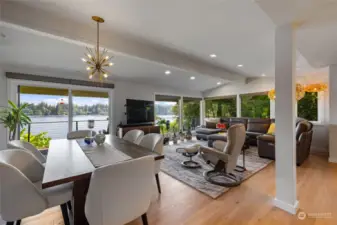Great room with wrap around windows connects to the lake & nature.  Engaging conversations with the kitchen, dining & seating area in this large open design.