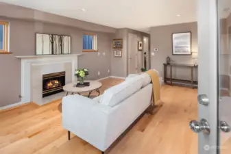 Enter in on a formal living room with pristine hardwoods and a gas fireplace.