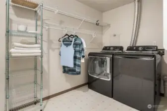 The laundry room is spacious with storage and a laundry chute.