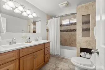 Full size bright and spacious bathroom with brand new quartz countertops and double sinks.