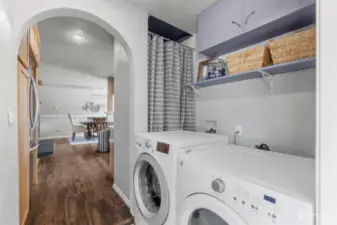 Utility room with nice washer and dryer set that stays with the home.  Storage space above and behind the curtain is the hot water tank.