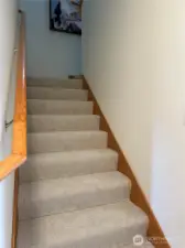 Upstairs, you’ll find two comfortable guest bedrooms and a full bath, offering a private and versatile space for visitors, hobbies, or a home office.