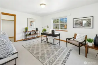 Bedroom two is currently styled as a home office, showcasing the room’s flexibility. Both upstairs guest rooms feature spacious closets on either side, providing ample storage and functionality.