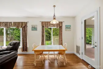 Breakfast nook off of kitchen and family room, with entrance out to covered deck