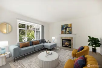 Formal living room thoughtfully designed offering a perfect blend of of comfort and style, with gas fireplace and large windows that frame lovely views of your front landscape (this room is virtually staged)