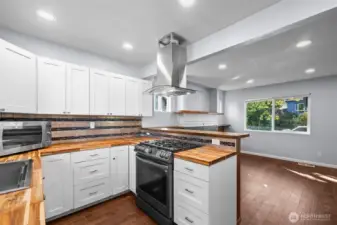 Gorgeous butcher block counters and gas range!