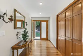 Wide entry way with frosted glass French doors leads into this beautiful home.  Large coat closet & sconce lighting.