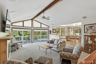 The great room with vaulted ceilings flows from the entry way. Huge sliding glass windows to catch a nice breeze off the water.  Built in speakers & brand new carpet all through out the home.