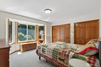 Guest bedroom with 2 large closets and continentals into the guest bath via a barn door. Bay window adds in additional light.