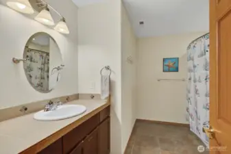 Full guest bath down with tile flooring.