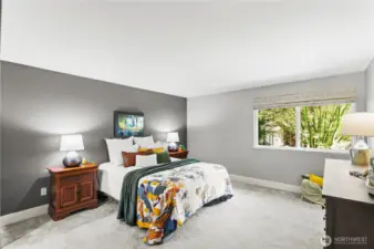 Expansive master bedroom with beautiful views of the manicured backyard and extensive closet space.