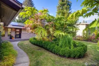 Outdoors, enjoy a level, landscaped yard—designed by a master gardener—with patio, mature plantings, and a tucked-away vegetable garden. The garden is prepared for winter at the moment, but there are hundreds of bulbs and surprises to come in the spring. The gardens are equipped with soaker hoses that are controlled with an APP.  The solar panels were installed in 2022 for ultimate energy efficiency, along with all new double-pane windows in 2024 and LED lighting throughout the home.