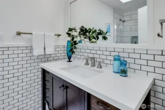 Updated subway tiled full bath serves two of the bedrooms.