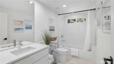 Full bath with tub/shower combo.