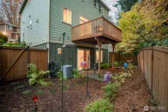 Private, fully fenced backyard with thoughtful landscaping and lush greenery—ideal for play, pets, or peaceful relaxation.